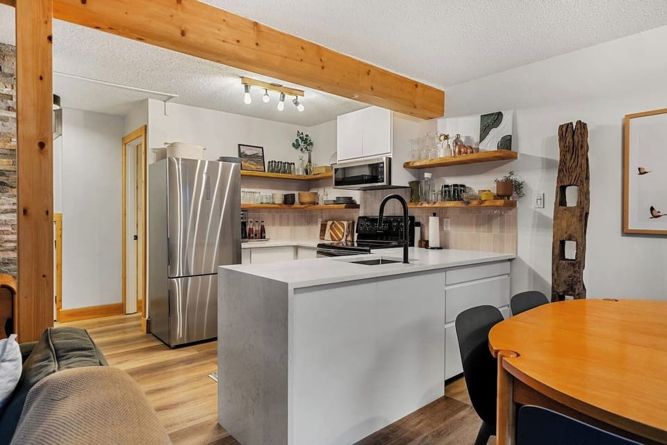 Full kitchen with a drip coffee machine, ground coffee, tea, sugar, and basic condiments (ketchup, mustard, relish.)