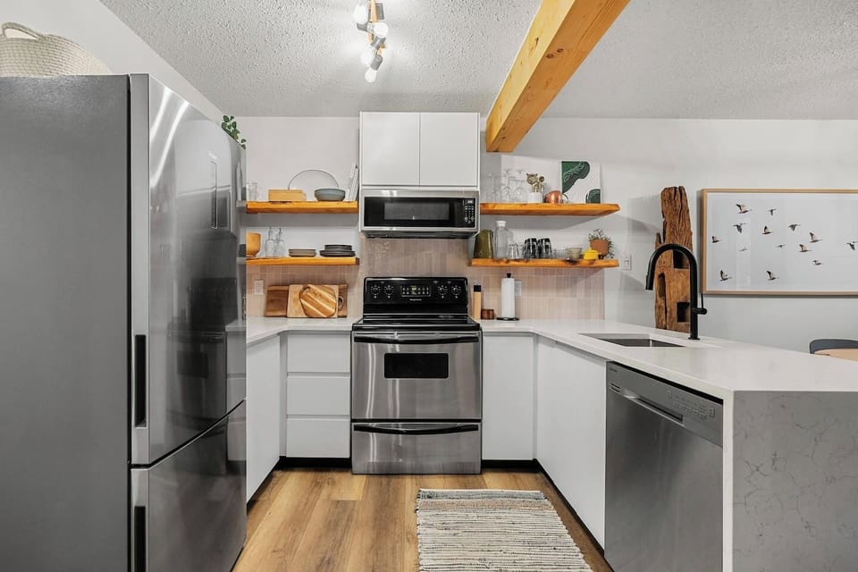 Full kitchen with a drip coffee machine, ground coffee, tea, sugar, and basic condiments (ketchup, mustard, relish.)