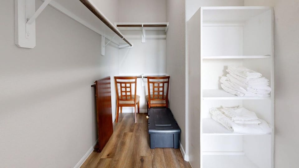 Spacious primary bedroom closet with organized storage
