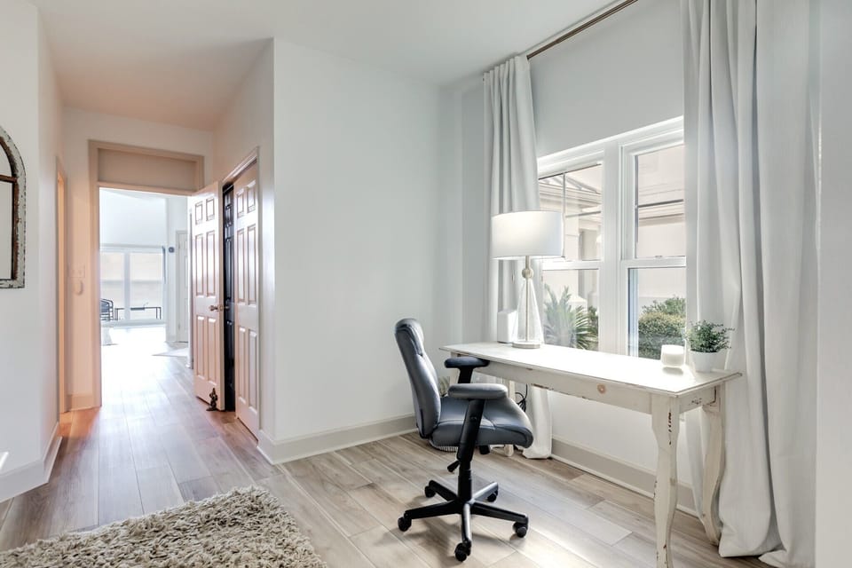 First floor guest suite with king bed, tv and dedicated work station.