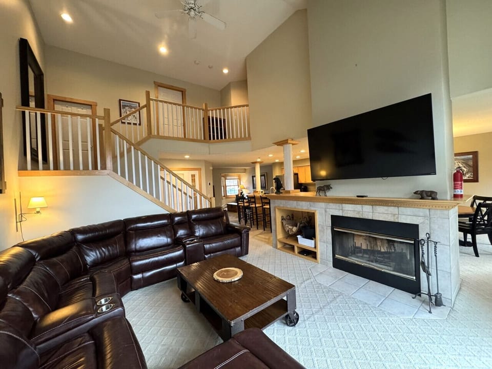 Large Family room with leather couch, Fireplace & 65` smart Tv
