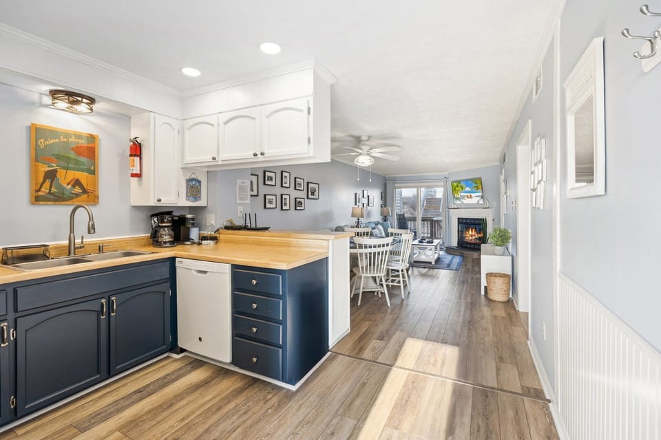 The updated kitchen features refreshed cabinetry, new appliances, and everything needed to prepare meals during your stay.