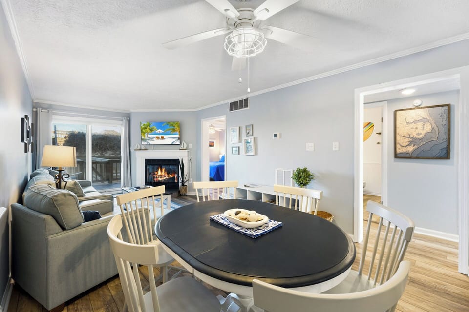 The dining area offers a welcoming space to enjoy meals together or plan your next Outer Banks adventure.