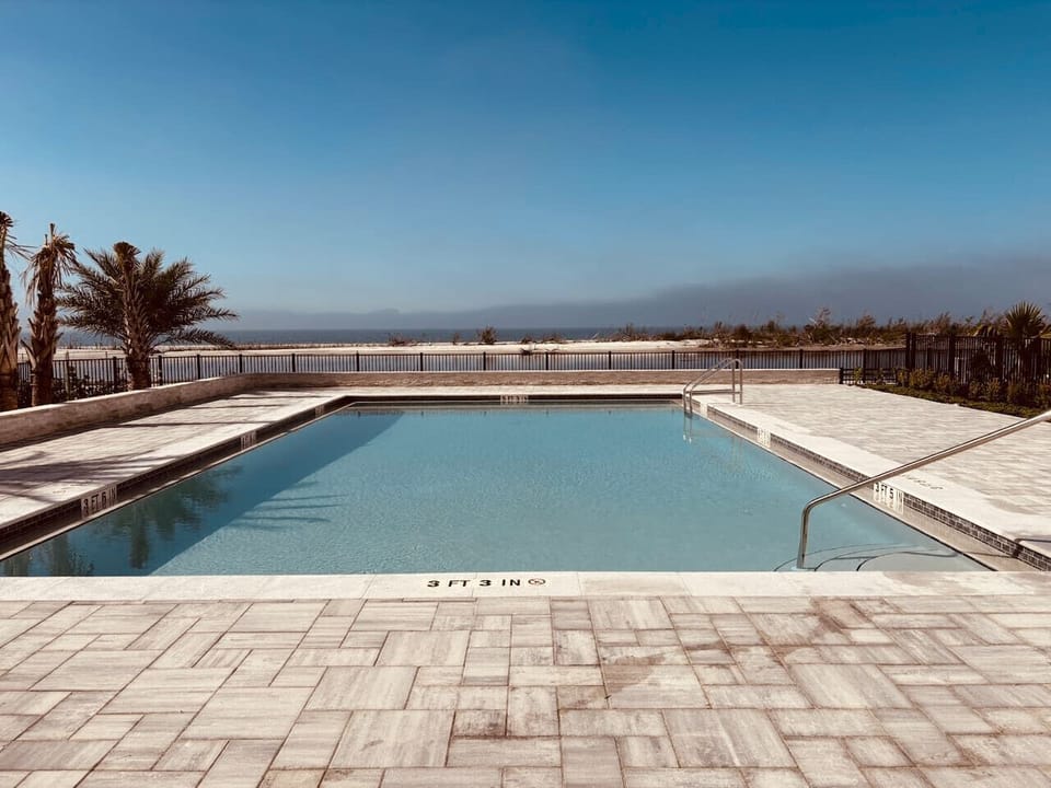 A refreshing dip with a view—our newly updated pool overlooks the Gulf and is available for all guests to enjoy.