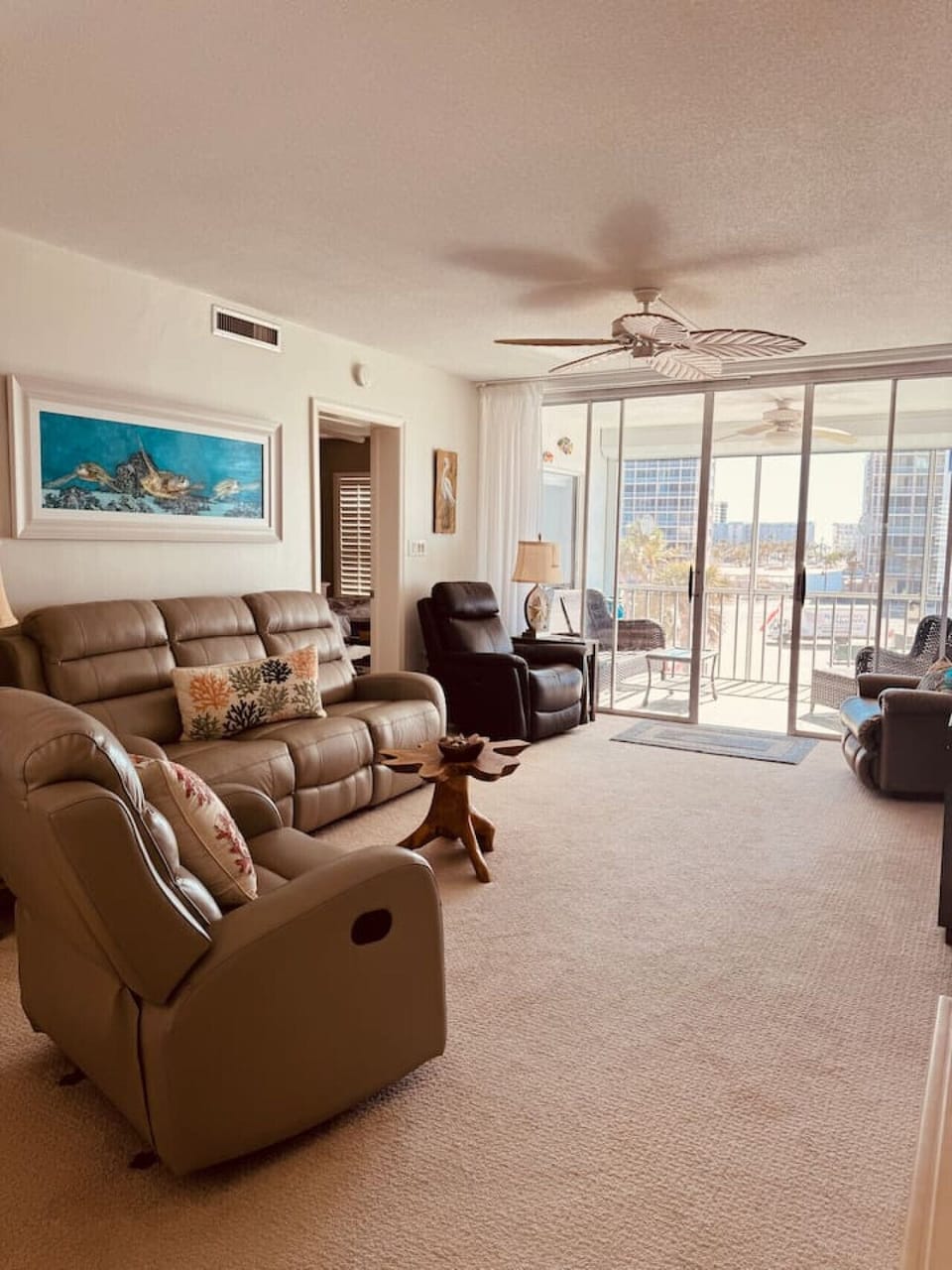 Relax in the living room featuring plush leather seating and a large Smart TV—ideal for evenings in.