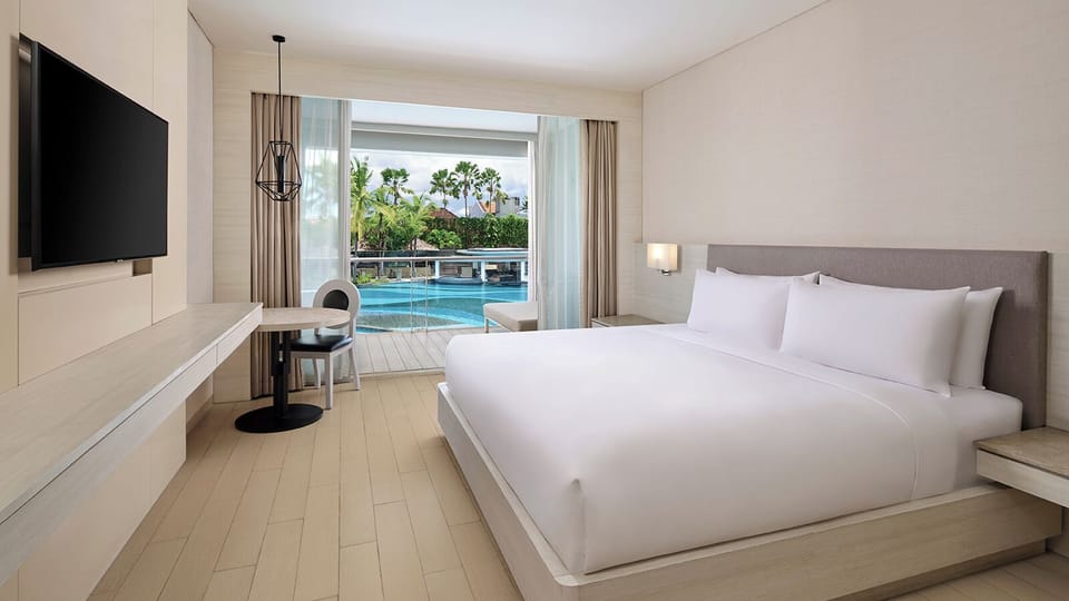 Deluxe Room, 1 King Bed, Balcony, Pool View | Free minibar, in-room safe, desk, laptop workspace