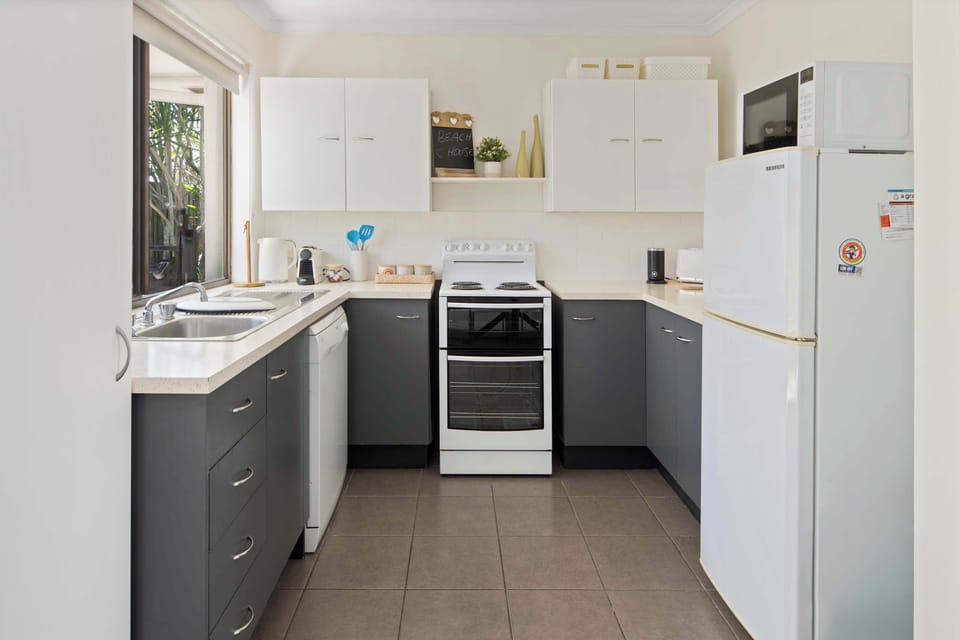 A bright, well-equipped kitchen with everything you need for easy holiday cooking—ideal for preparing casual meals, beach-day snacks, and shared family dinners.