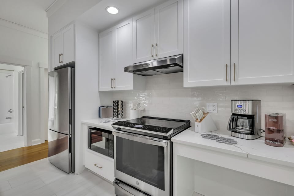 Fully equipped kitchen with stove, microwave, and ample counter space.