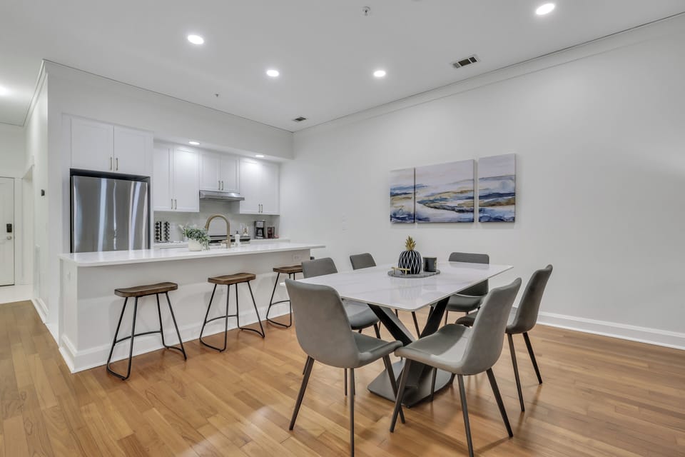 Dining and kitchen area with modern appliances and decor.