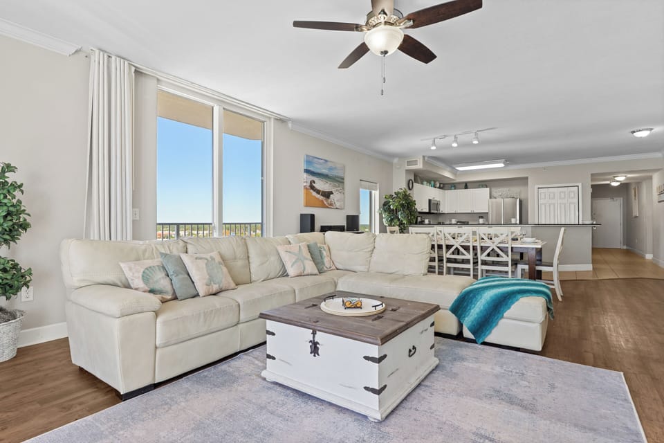 Open-concept living space with ceiling fan and modern appliances.