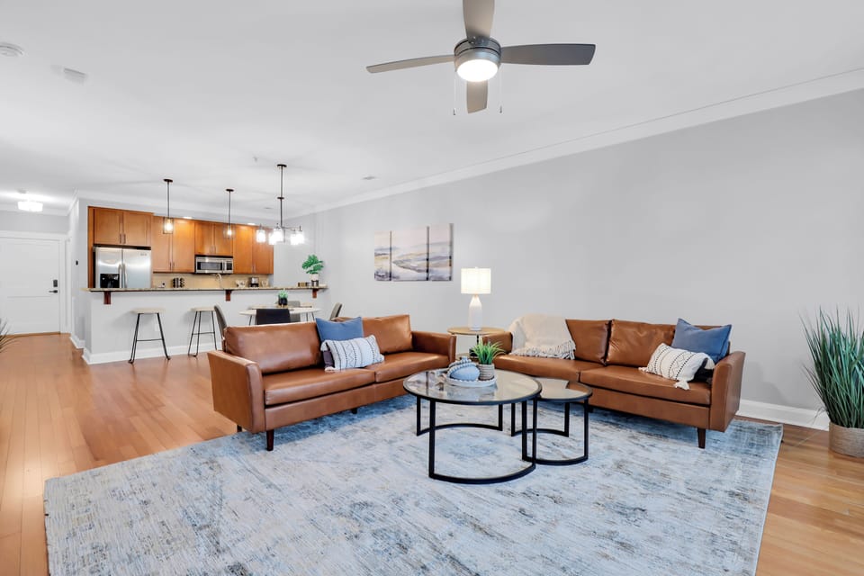 Living area with a ceiling fan and a comfortable sofa.