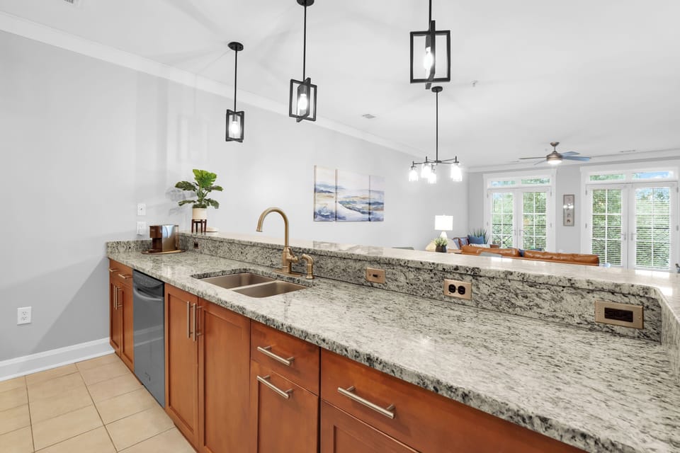Kitchen features modern appliances and spacious countertop.