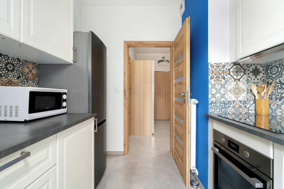 The kitchen's contemporary decor complements the apartment's style.