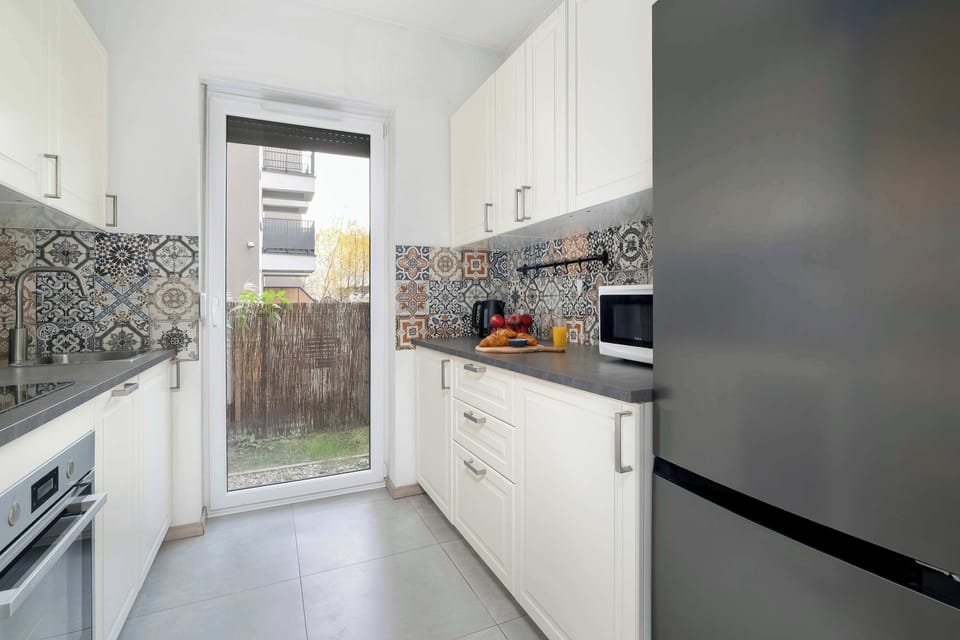 The kitchen's sleek design includes all necessary cookware and utensils.