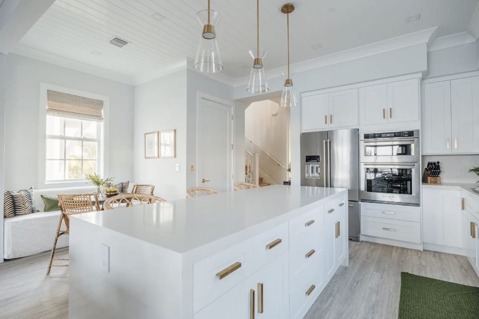 Spacious chef’s kitchen with oversized island and modern stainless appliances.