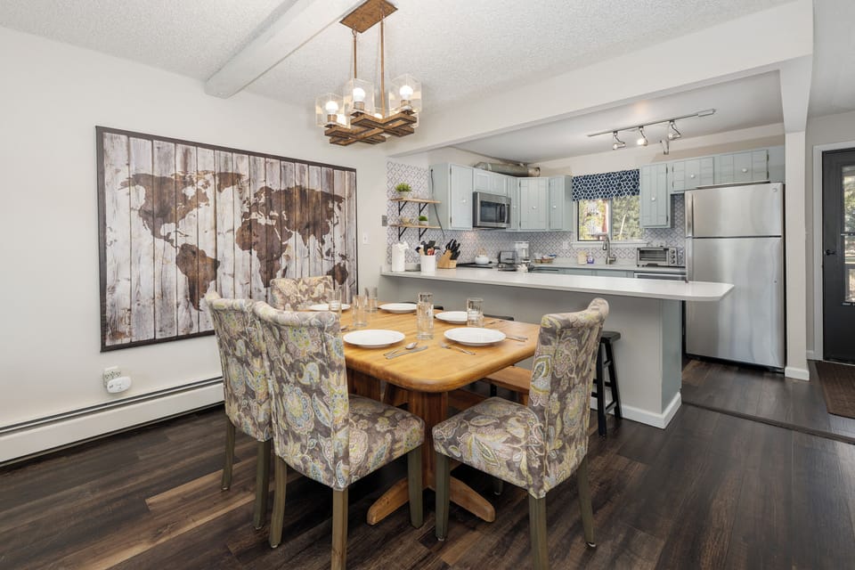Your modern open-concept kitchen and dining space features warm wood floors, stylish lighting, and everything needed for memorable meals together.