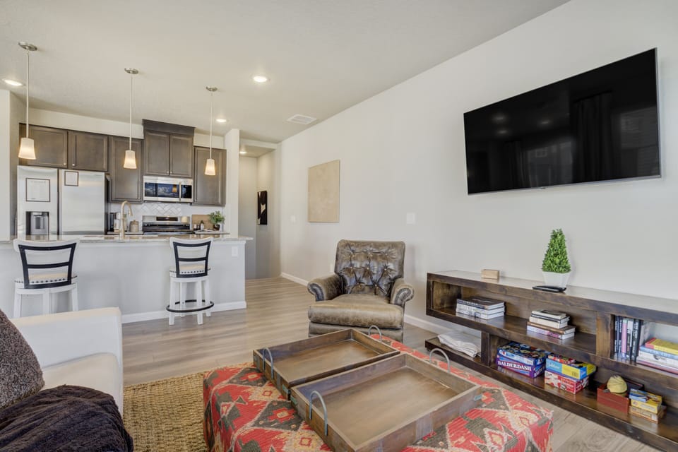 The open living room, kitchen, and dining area create a bright and comfortable space to gather.
