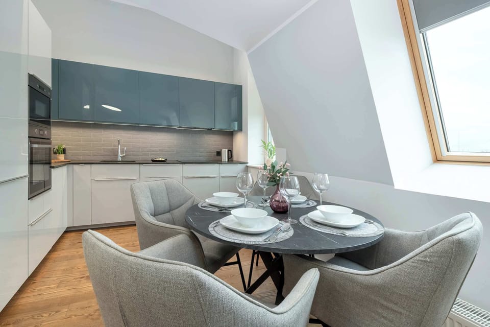 Open kitchen with dining space under skylights.
