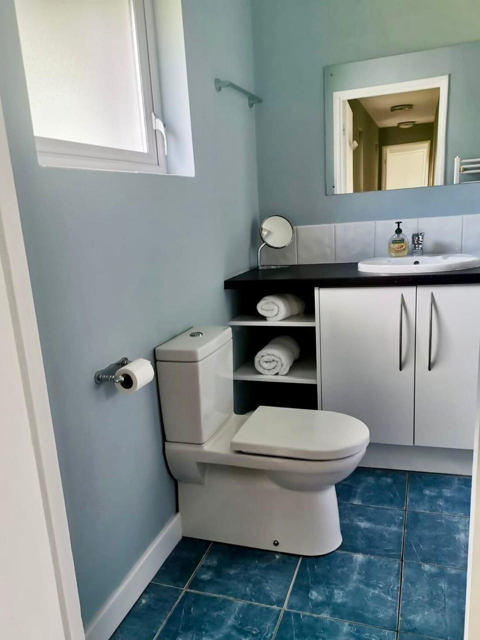 Bathroom in hallway just outside of bedroom 1. 