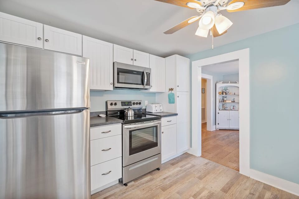 Stainless Appliances and beach white cabinetry.