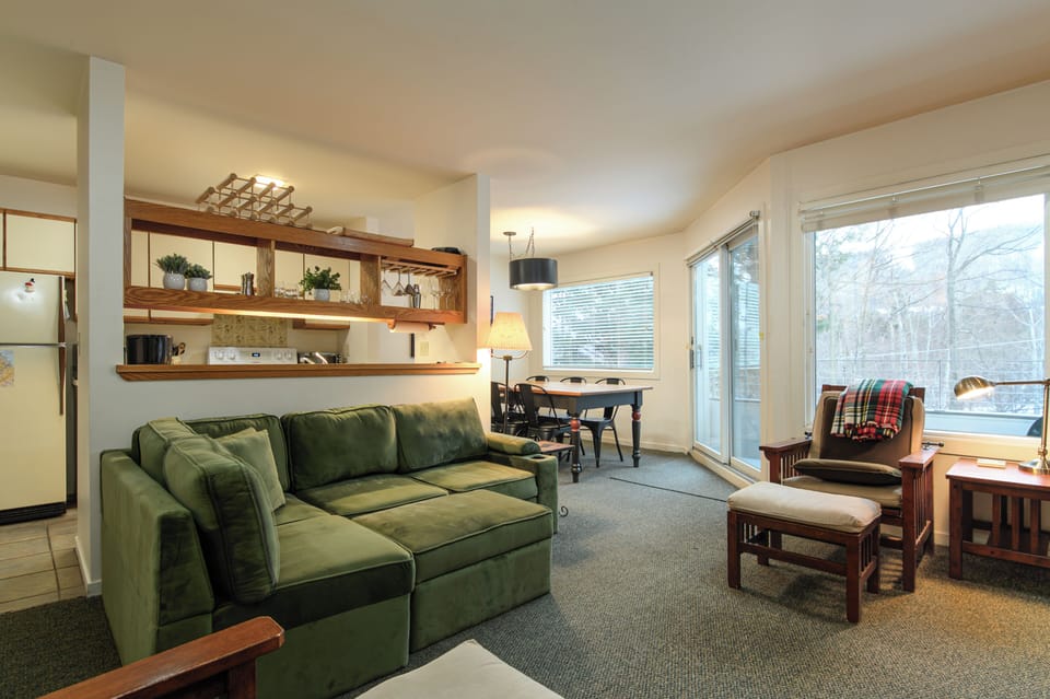 Relax in this mountain retreat with an open living space, plush seating, and large windows framing serene winter views - your perfect post-adventure escape.