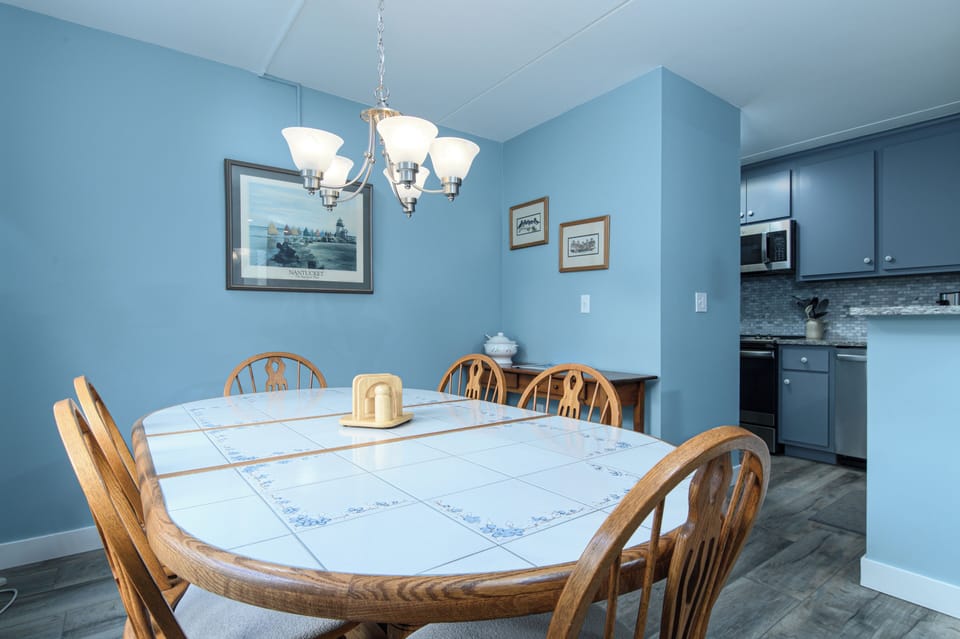 Gather around your spacious dining table for memorable meals together, with the fully equipped kitchen just steps away for convenient meal preparation.