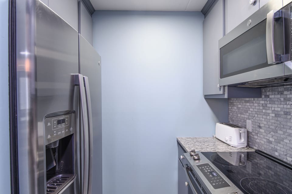 Your fully-equipped kitchen features modern stainless steel appliances and sleek granite countertops, perfect for preparing meals during your stay.