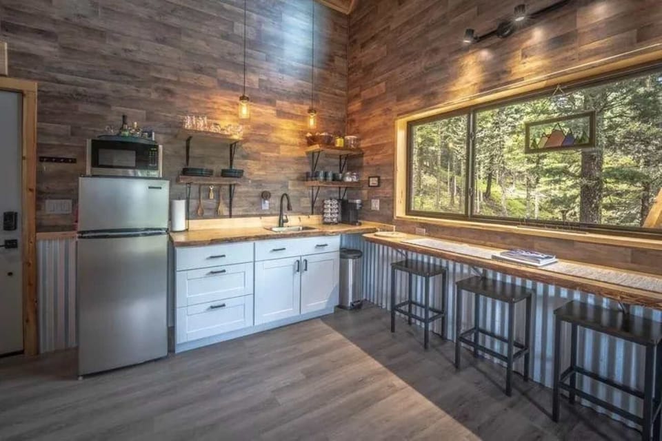 Brew your morning coffee in the kitchenette with a forest view