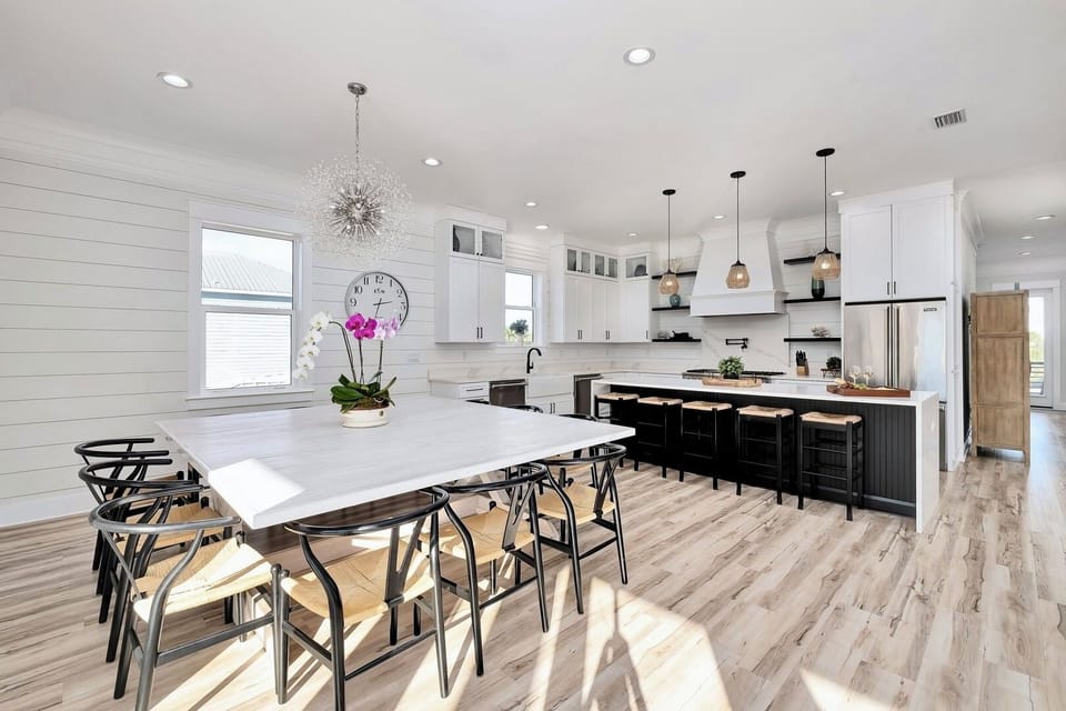 2nd Floor - Spacious dining room designed for large groups—seat 12 at the main table with room for 4 more at the marble kitchen bar. Perfect for family dinners, holiday meals, and gathering after a day at the beach in this luxurious Miramar Beach retreat.