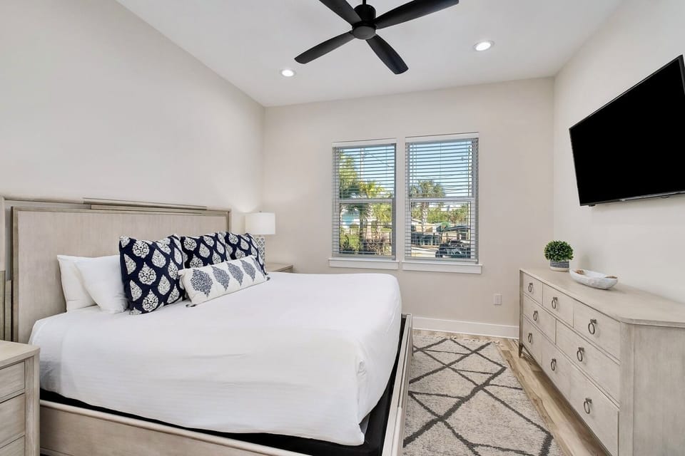 1st Floor - Relax in this first-floor King Suite featuring a plush bed, ensuite bathroom with walk-in shower, and a 4K Smart TV. Perfect for guests who prefer easy access to the pool, game room, and outdoor living spaces. 