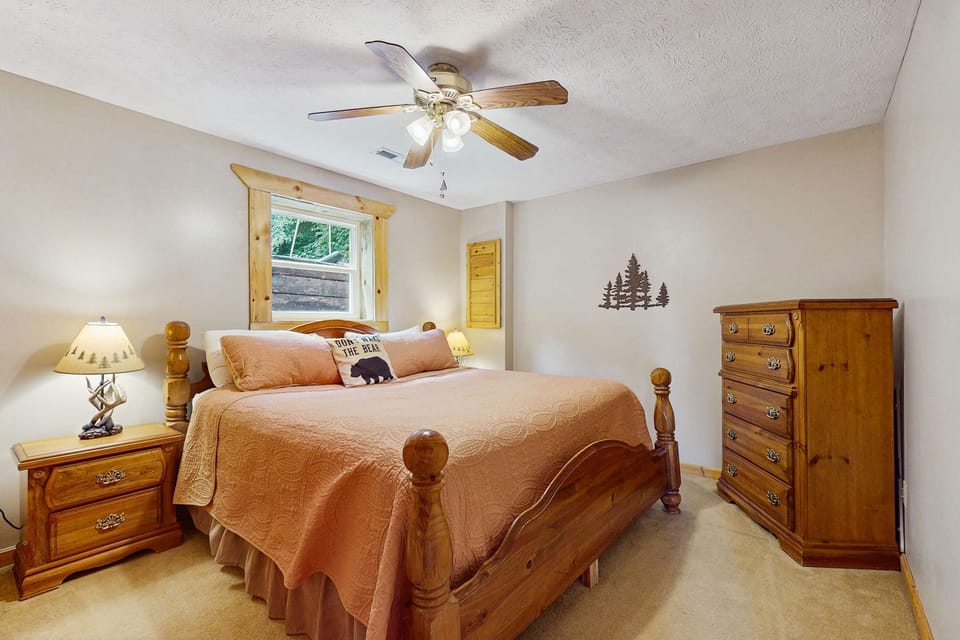 Bright room with wooden decor, comfy bed, and nature views for a peaceful stay!