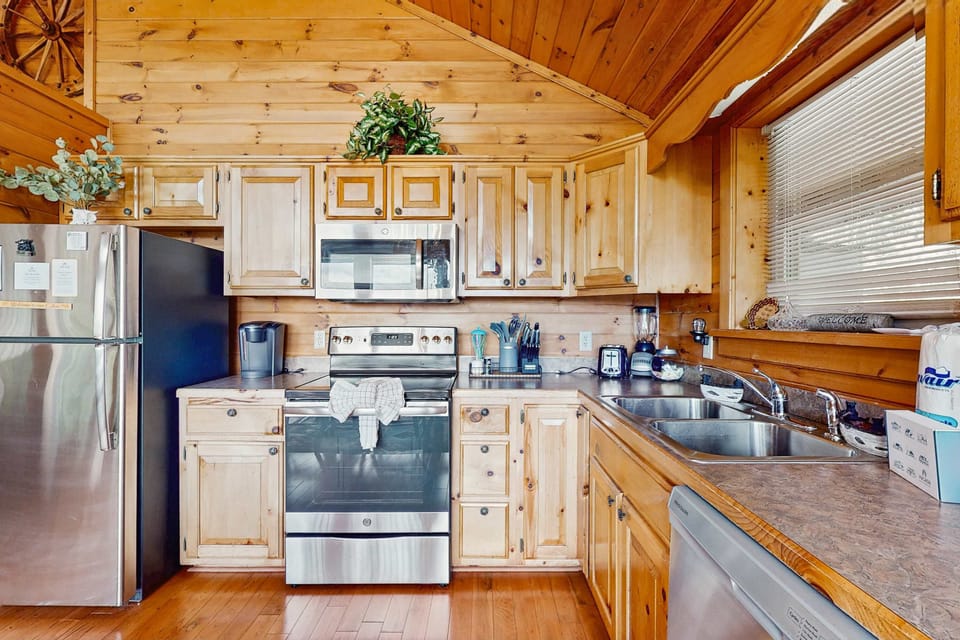 Kitchen haven awaits. A stylish wood accents, modern appliances, and all you need to whip up delicious meals!