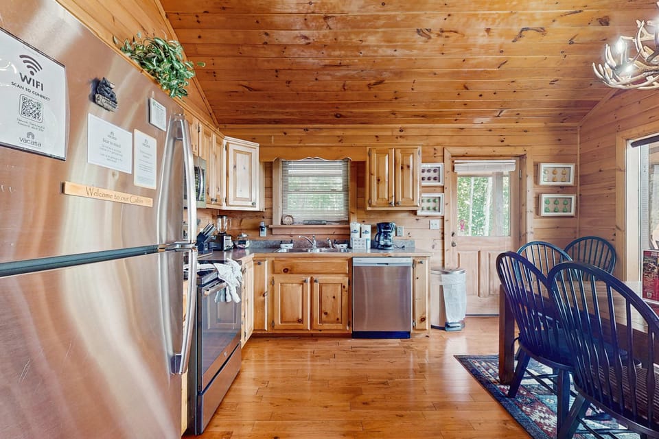 Sip your morning coffee at the rustic dining table with views of the surrounding woods!