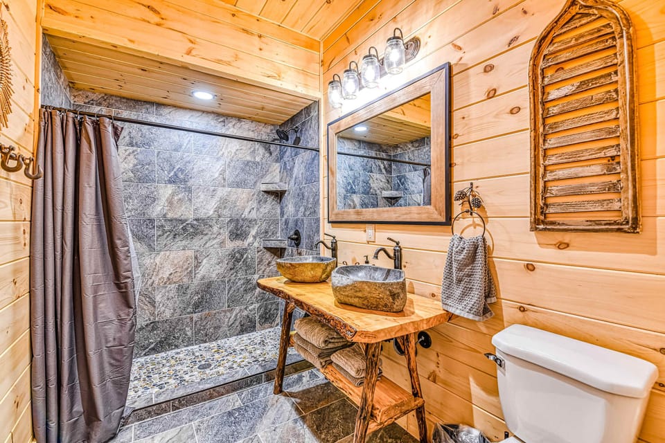 Luxurious Bathroom Oasis, experience sleek stone sinks and rustic charm in a serene retreat!