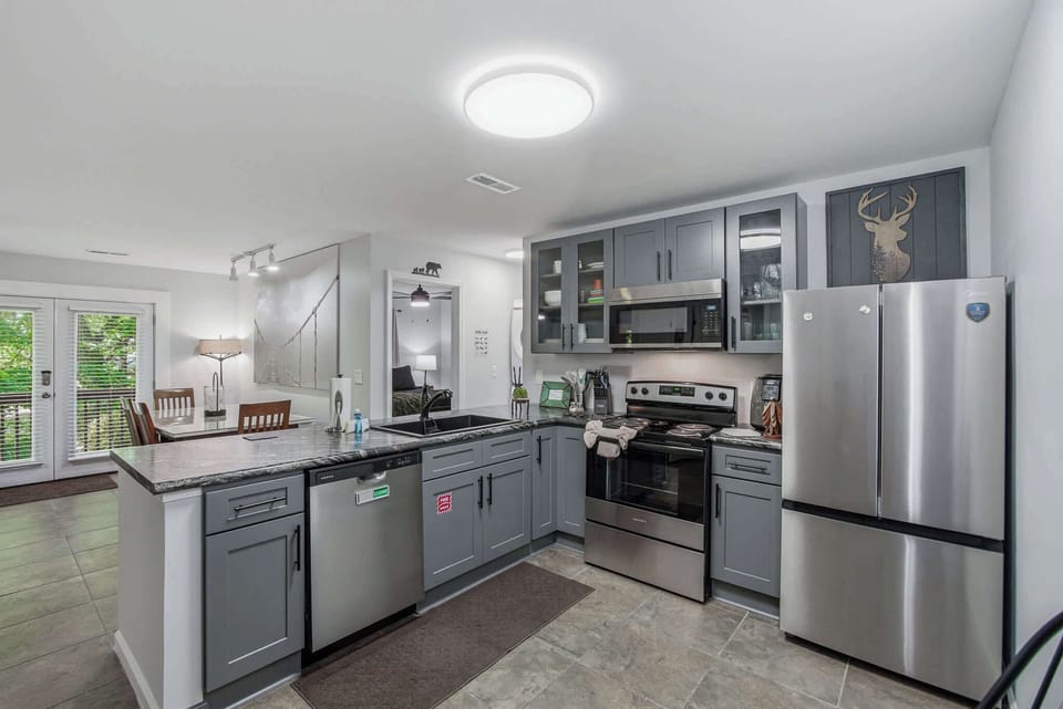 Fully equipped kitchen with stove, dishwasher, and ample counter space. Perfect for home-cooked meals.