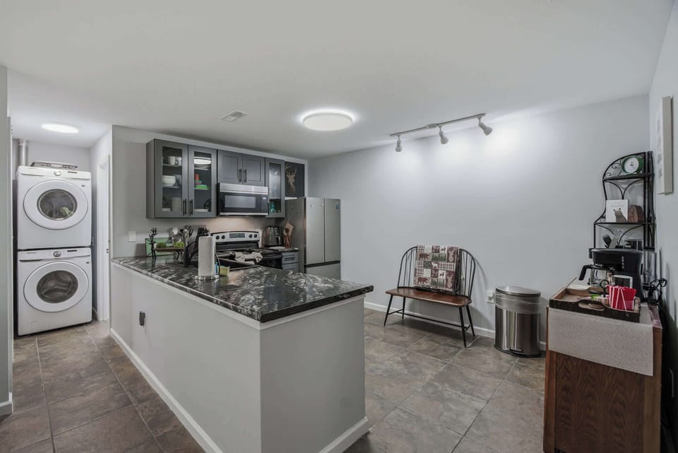 Stylish kitchen with rustic mountain mural, full appliances, and tile flooring. Great for family meals and longer stays.