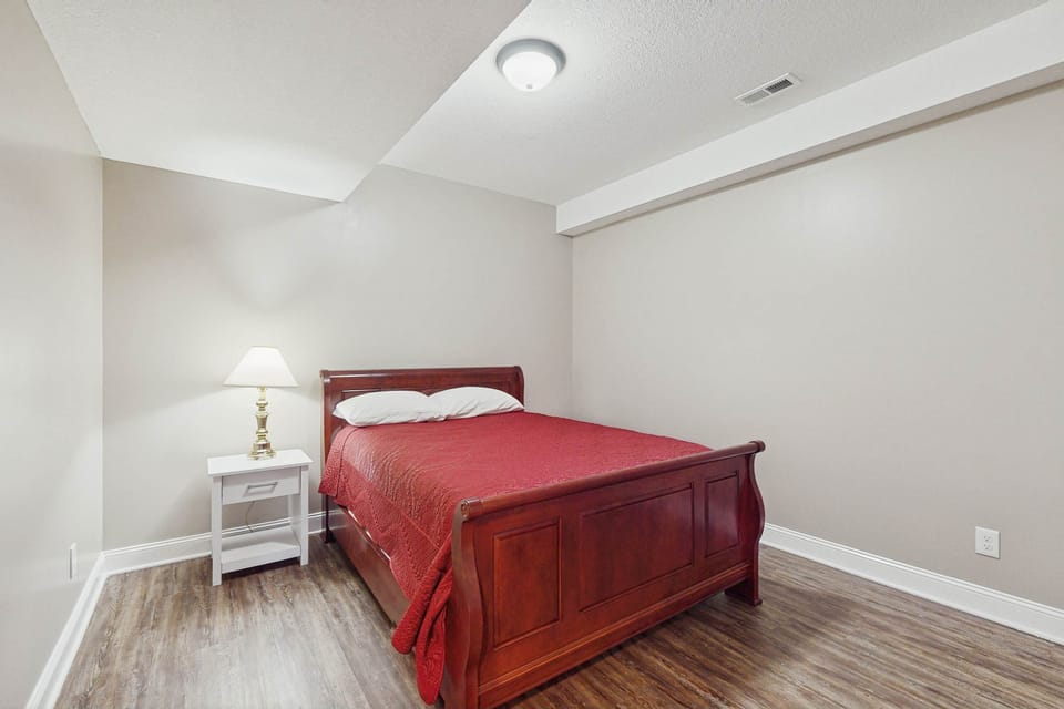 Enjoy restful nights on a plush bed with warm hues and soft lighting!