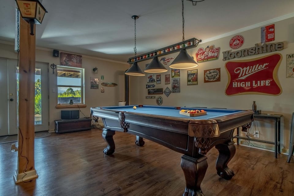 Challenge friends to a game on the classic pool table beneath stylish lighting!