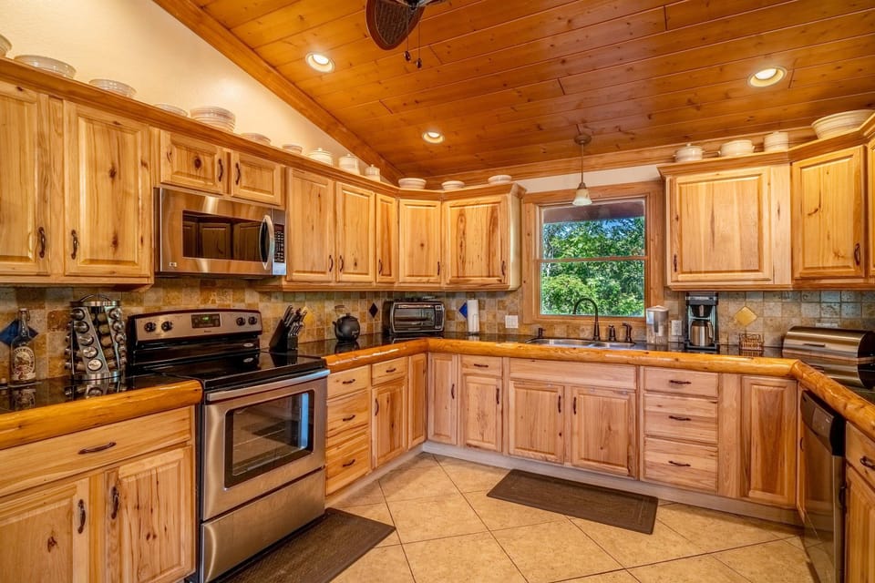 Delight in a gourmet cooking haven with stunning wood accents and scenic views!