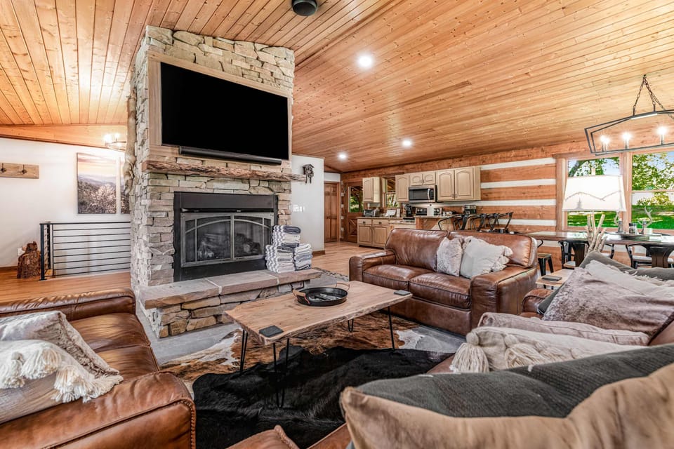 Experience rustic charm with wooden beams, a cozy fireplace, and inviting seating!