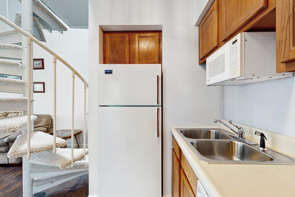 Experience culinary delights with modern appliances and a chic spiral staircase!
