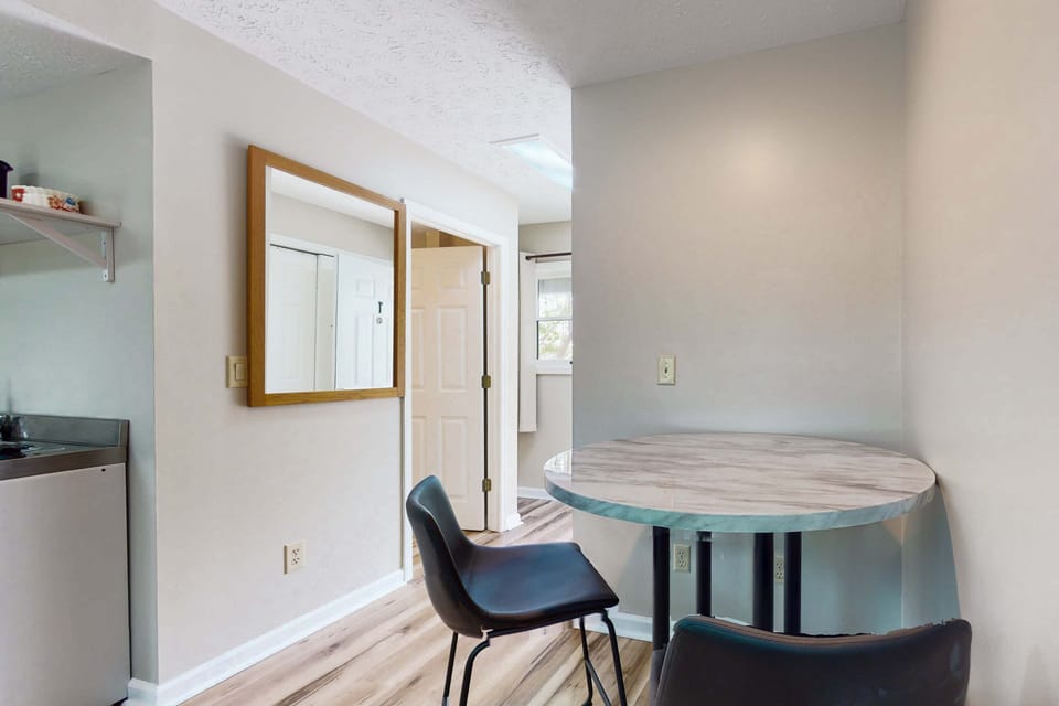 Cozy dining nook for meals or remote work. Great for business travel and longer stays. Studio suite with table seating, quiet workspace, convenient layout, and easy access to kitchenette.