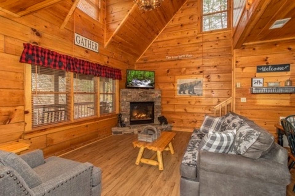 Relax by the stone fireplace and enjoy the stunning wooded views! Perfect for gatherings!