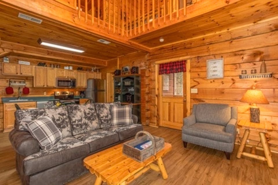 Embrace rustic charm with wooden accents and a comfy sofa for unforgettable moments!