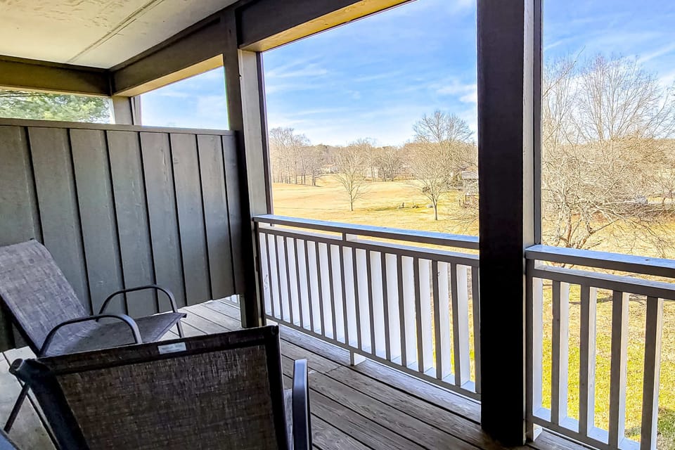 Private covered balcony with chairs & wide open views. Perfect for morning coffee, fresh air & sunsets. Quiet hideaway, scenic overlook, couples retreat, long-stay getaway.