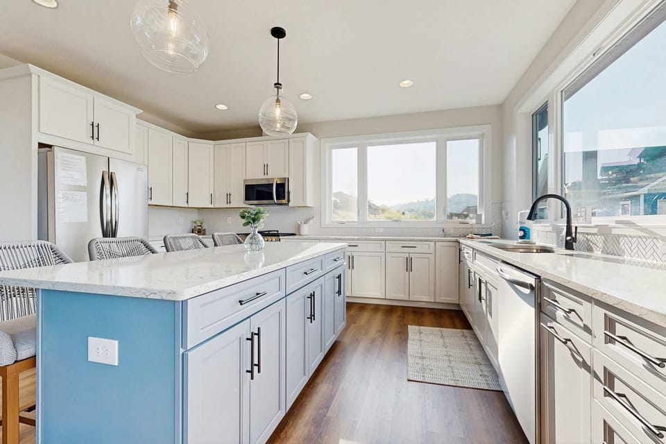 Kitchen oasis awaits. A bright, modern space with stunning views and stylish seating for culinary adventures!