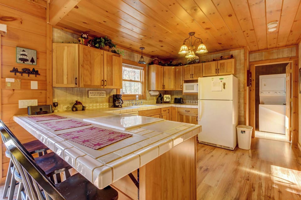 Bright, wood-paneled haven with modern appliances and a charming breakfast bar!