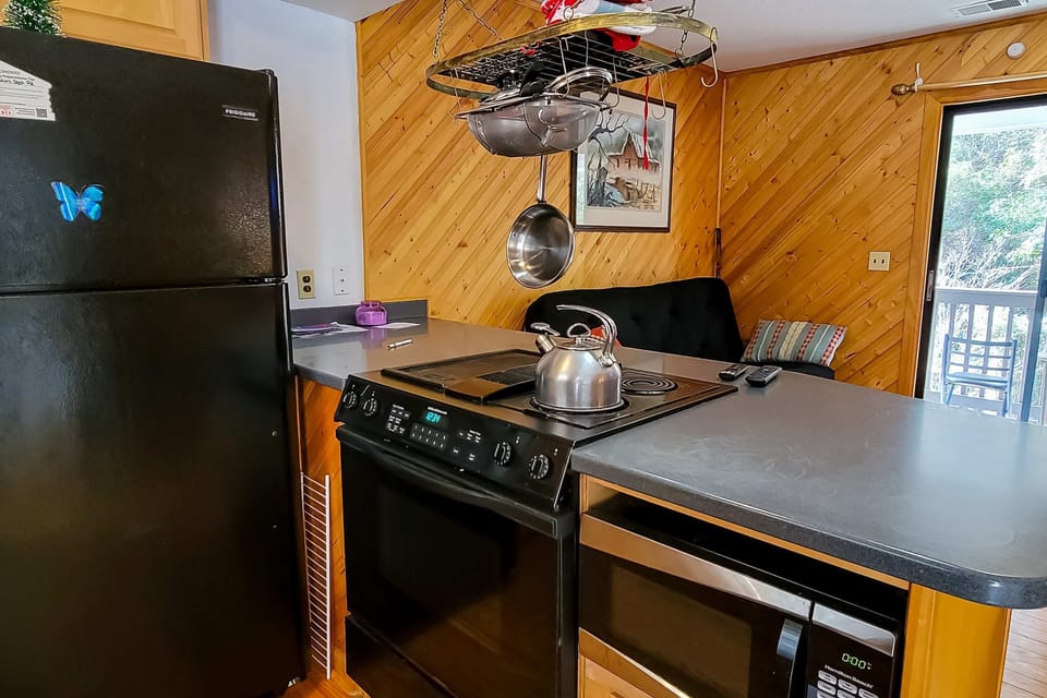 Enjoy cooking fun in this chef's haven with sleek appliances and a scenic view!
