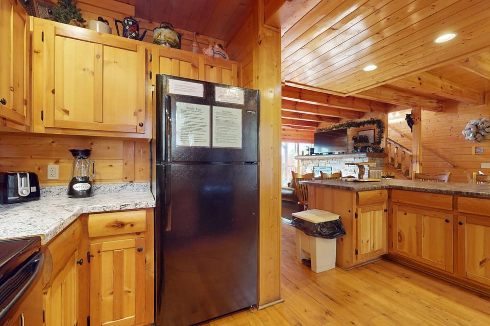 Whip up culinary delights in a rustic space with granite countertops and warm wood tones!