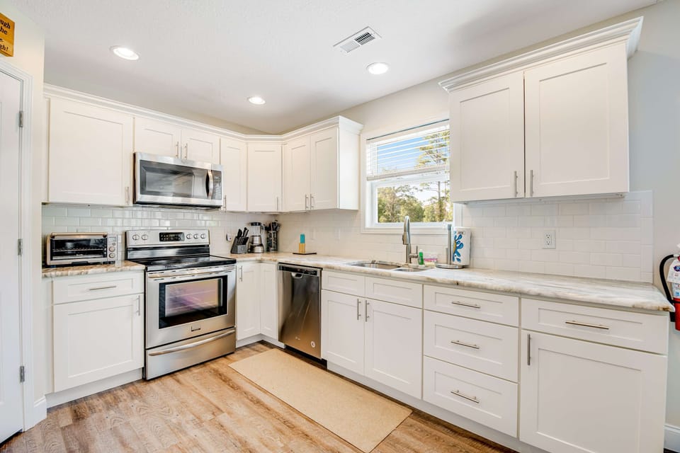 Bright and modern space with stainless steel appliances and scenic views for culinary delights!